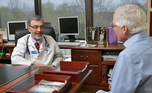 Dr. Erlebacher consulting with a patient